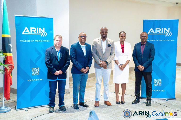 Presenters and officials with ARIN banners at the ARIN and CaribNOG seminar in St. Kitts
